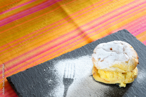 Bigne di San Giuseppe, Saint John's cream puffs on colourful tablecloth photo