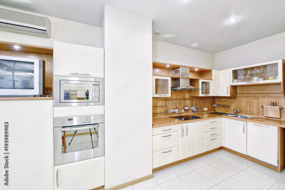 Modern design white kitchen in a spacious apartment.