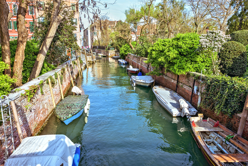 Daylight view to local canal with parked boats Daylight view to local canal with parked boats