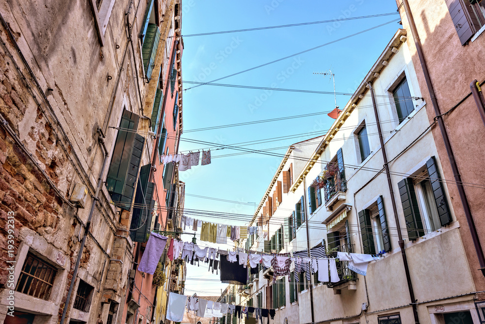 Daylight wide view from bottom to clothes line of laundry drying outdoors Daylight wide view from bottom to clothes line of laundry drying outdoors