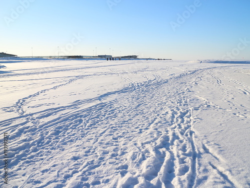 tracks on snowy ice on a winter day