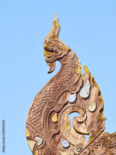 Naga at the end of the bargeboard on the gable roof of Wat Ton Kwen temple, Chiang Mai, Thailand photo