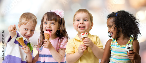 happy kids group eating ice cream at a party in cafe