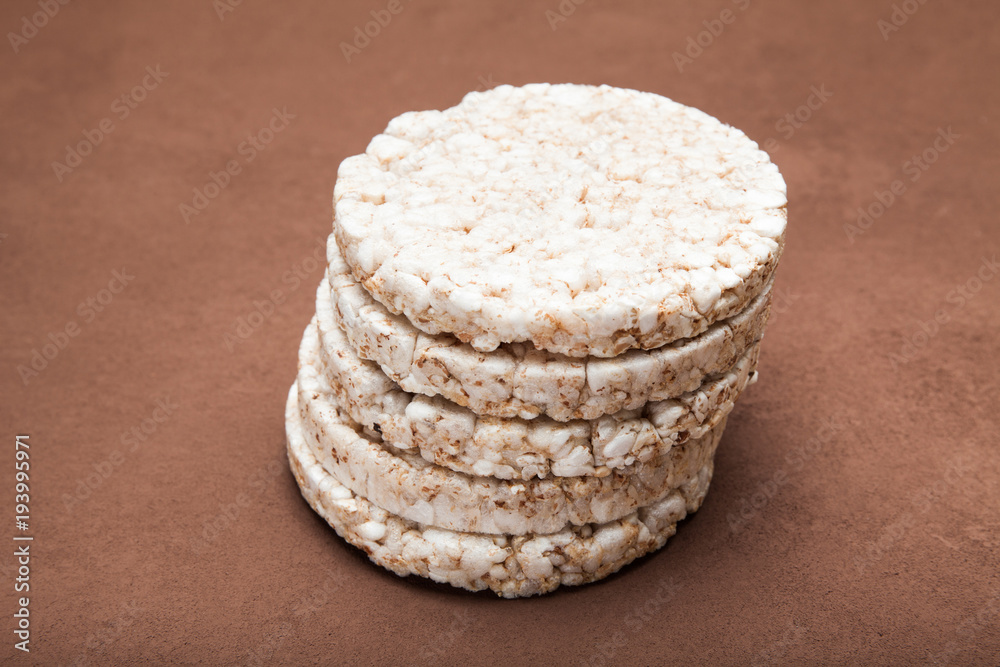 Rice dietary loaves laid out by a pyramid. Brown background. Rice dietary loaves laid out by a pyramid. Brown background.