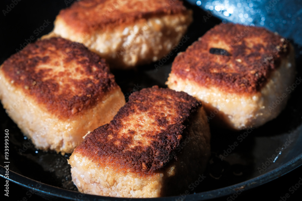 fried cutlets on a frying pan fried cutlets on a frying pan