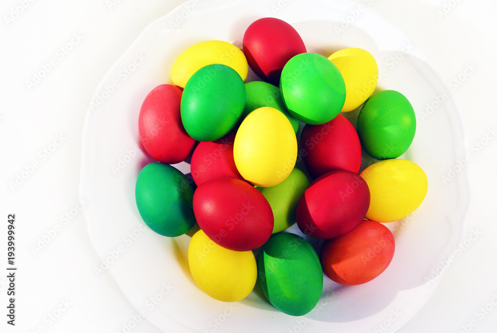 Colorful Easter eggs on white plate background. Holiday in spring season. top view composition. Colorful Easter eggs on white plate background. Holiday in spring season. top view composition.