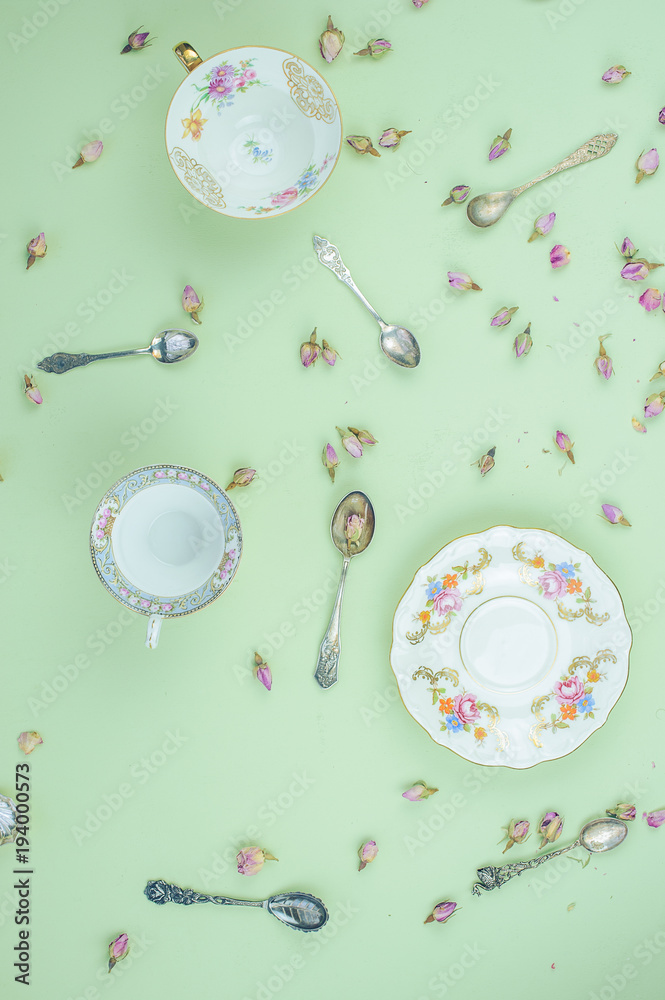 Naklejka premium Tea party concept, with porcelain plates and antique silver teaspoon