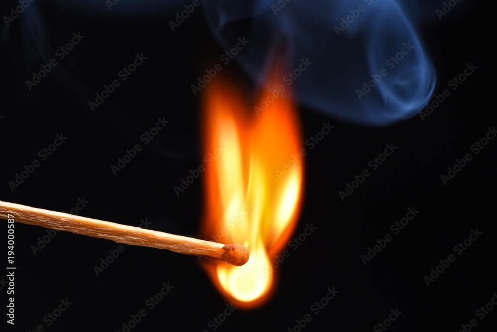 Burning match on a black background Burning match on a black background
