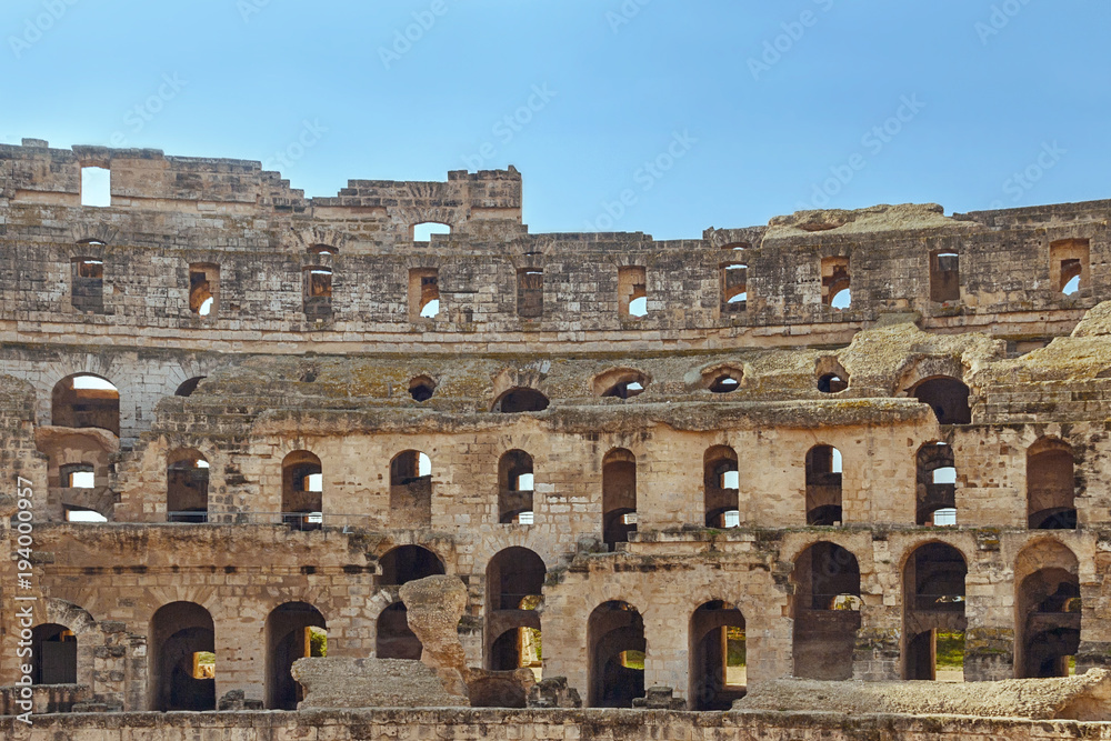 Antique wall with arches of El Djem Amphitheatre in Tunisia