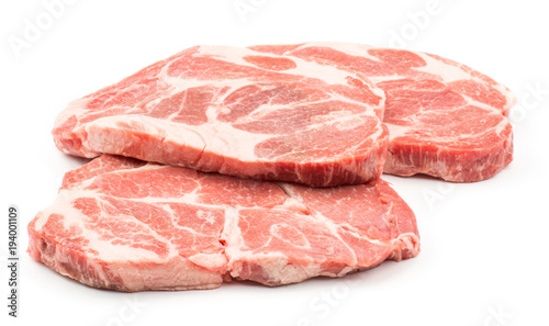 Three raw pork neck meat cuts isolated on white background fresh slices without bone .