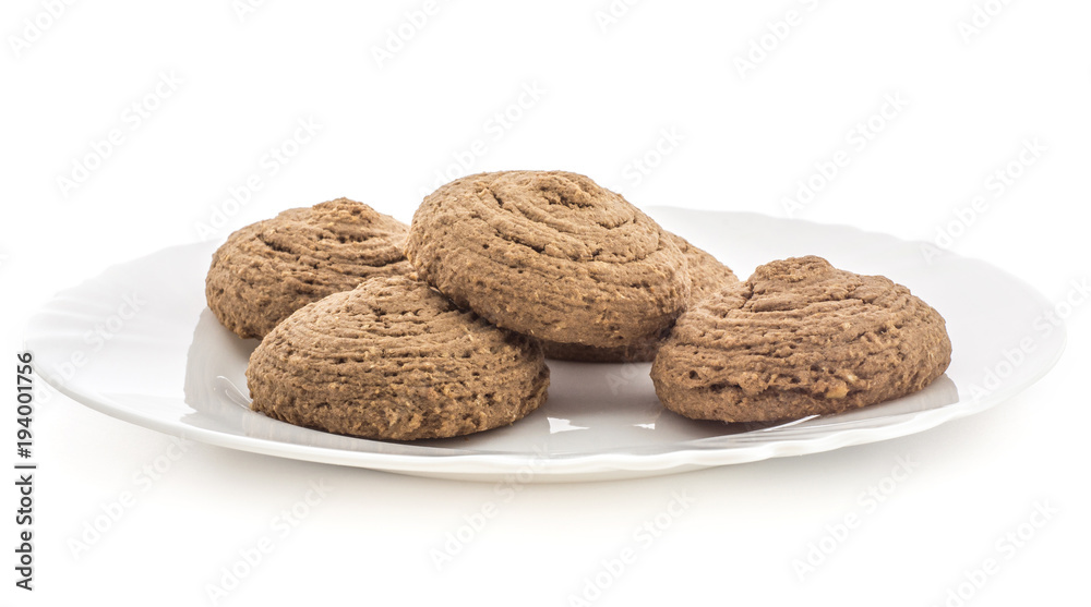 Cocoa oat cookies on a porcelain plate isolated on white background five drop shape brown crispy biscuits. Cocoa oat cookies on a porcelain plate isolated on white background five drop shape brown crispy biscuits.