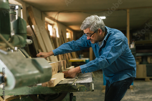 middle aged carpenter working in his workshop