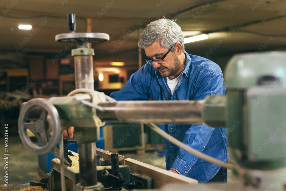 middle aged carpenter working in his workshop middle aged carpenter working in his workshop