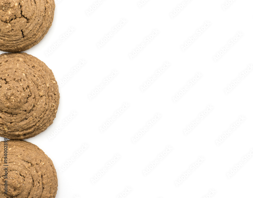 Three cocoa oat cookies in row top view isolated on white background drop shape brown crispy biscuits. Three cocoa oat cookies in row top view isolated on white background drop shape brown crispy biscuits.