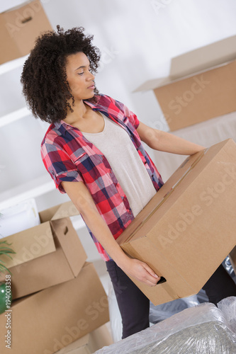 woman moving in carrying cartons boxes