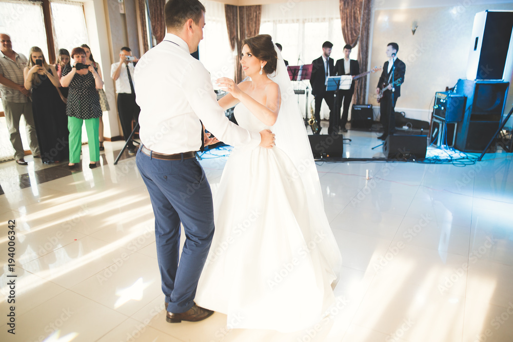 First wedding dance of newlywed couple in restaurant First wedding dance of newlywed couple in restaurant