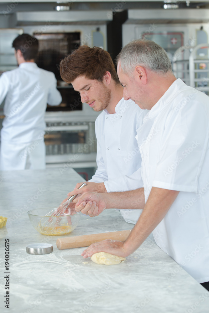 Fototapeta premium chef giving lesson to the intern
