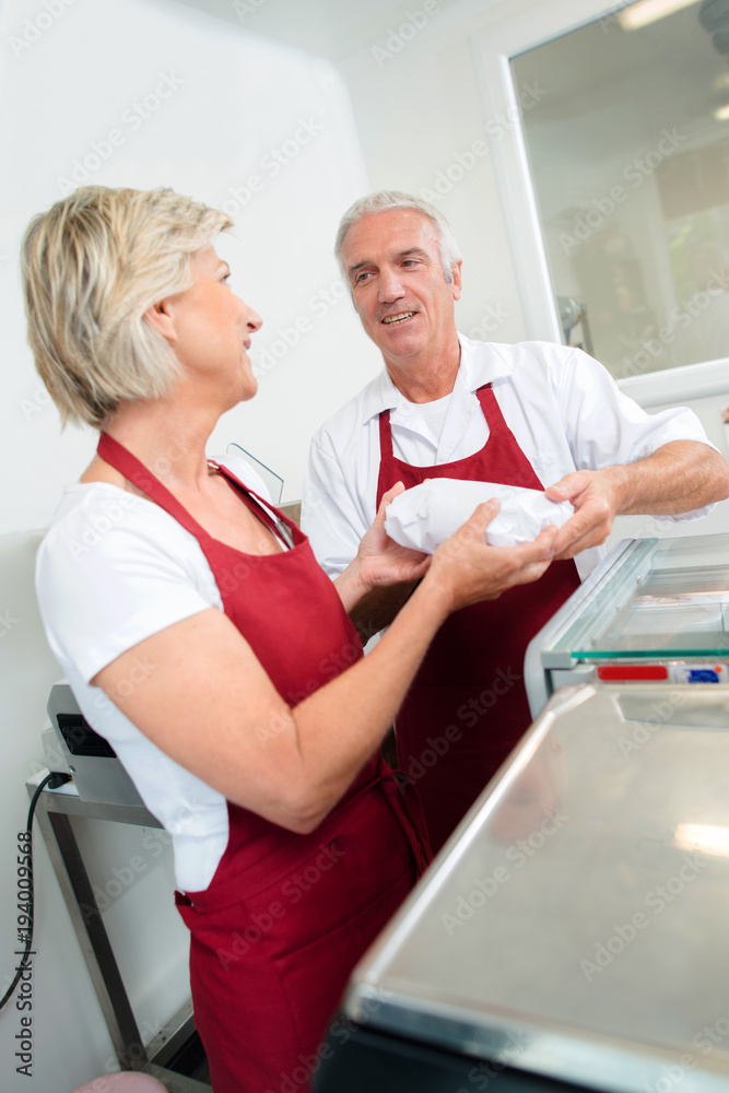Senior couple run a butcher shop Senior couple run a butcher shop