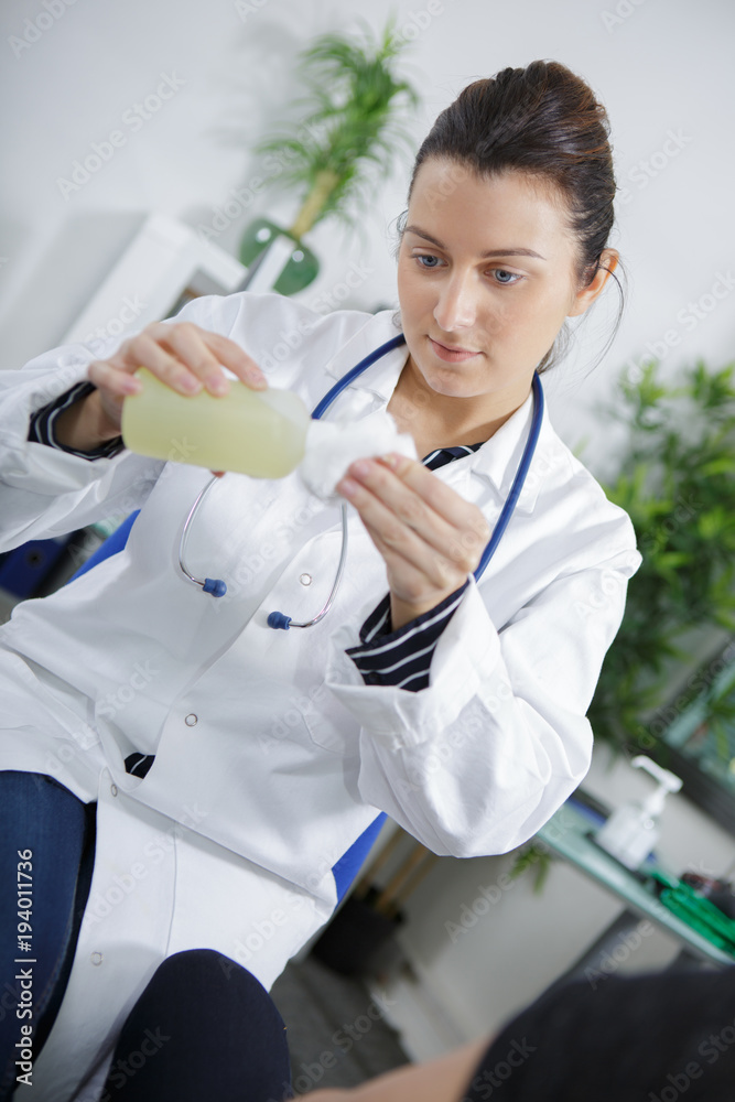 female doctor disinfecting item female doctor disinfecting item