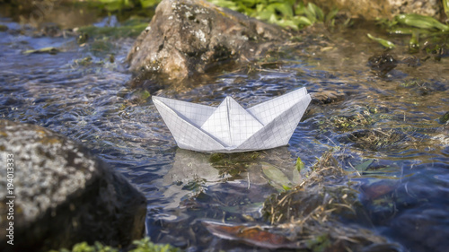 Paper Boat Floating in a Stream