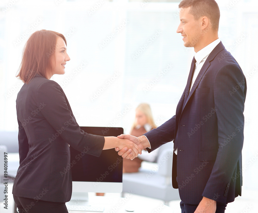 handshake business partners at the negotiating table.