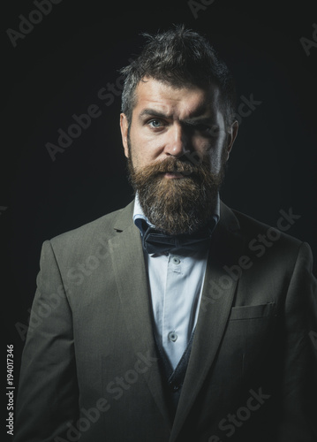 Hipster with stylish appearance looks forward. Man with beard