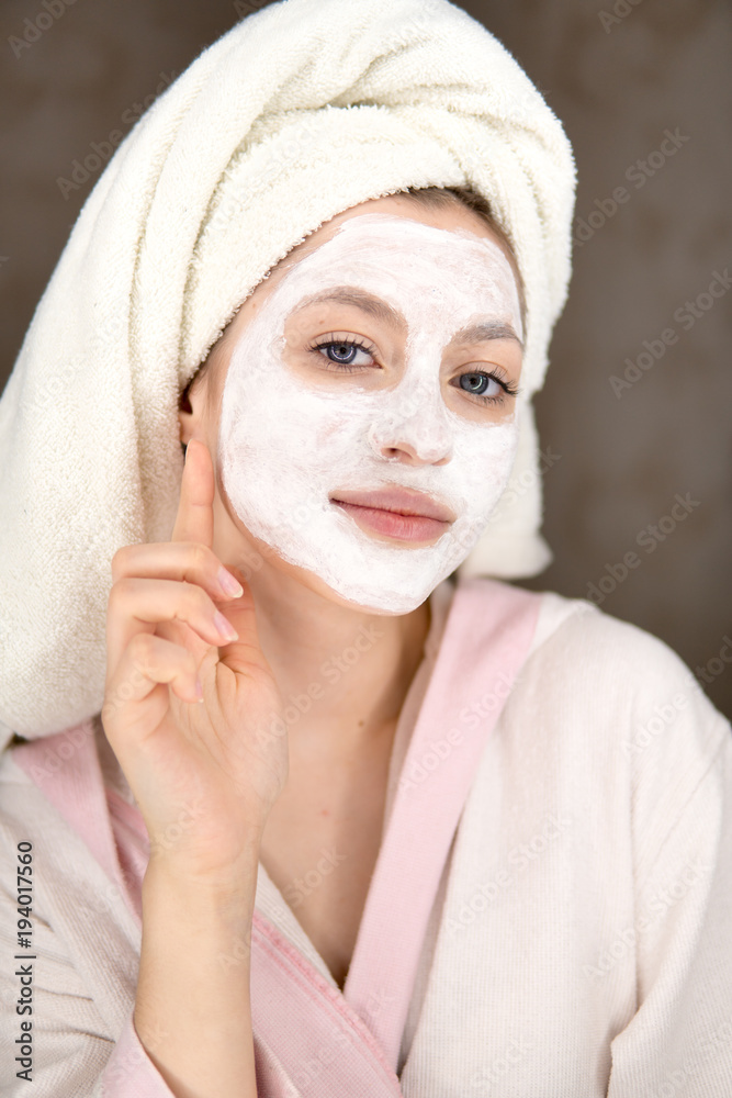 woman looks after the face makes a mask woman looks after the face makes a mask