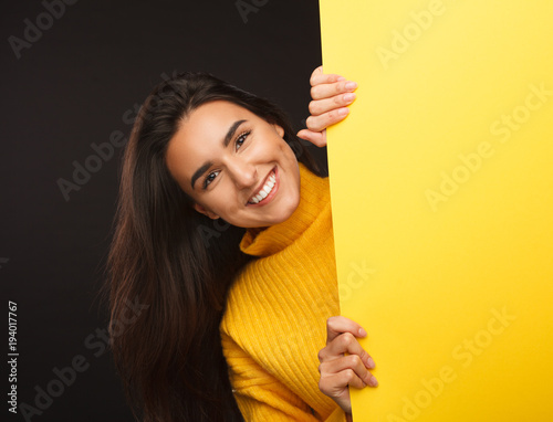 Wonderful girl showing yellow banner