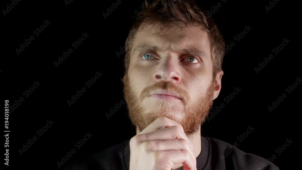 Thinking man isolated on black background. Caucasian male model. Thinking man isolated on black background. Caucasian male model.