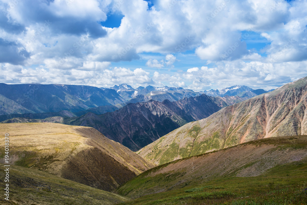 Summer Landscape of Eastern Sayan Mountains, scenic view with cloudy sky. Russia, Siberia.