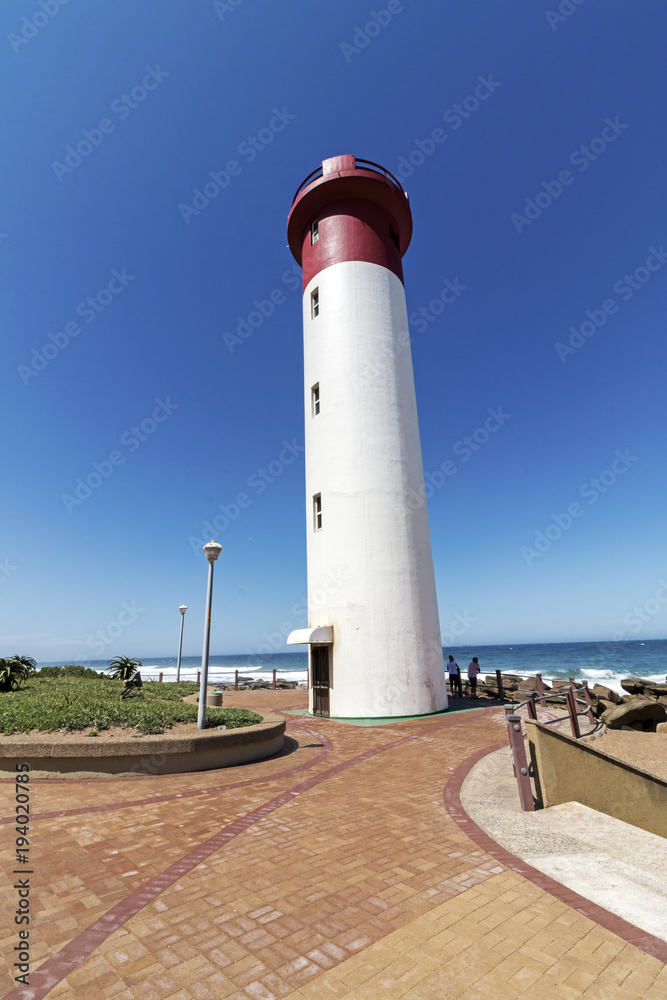 Portrait  Lighthouse on Paved Beachfront Promenade