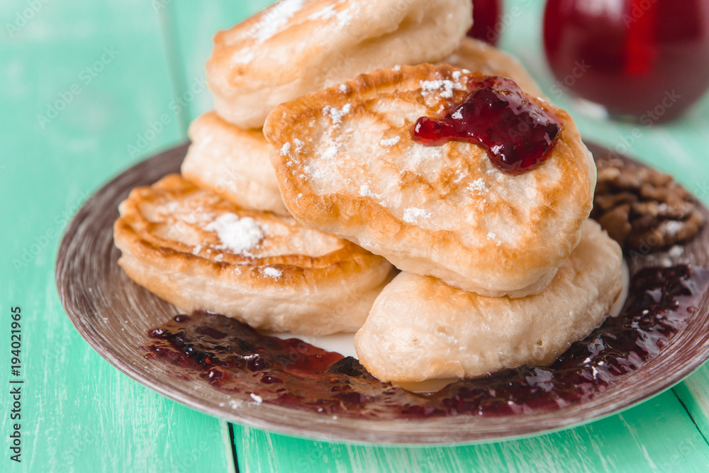 pancakes with jam and glasses of juice on a wooden table pancakes with jam and glasses of juice on a wooden table