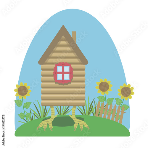 Fairytale bright izba on chicken legs with colorful sunflowers
