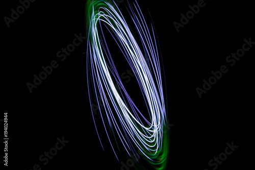Painting with light coming from the diode. A spiral outline drawn by a flashlight suspended on a string.