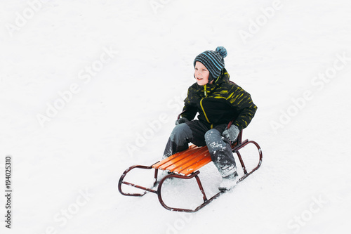 Little boy slide from the hump, smile to the camera and show his amotions