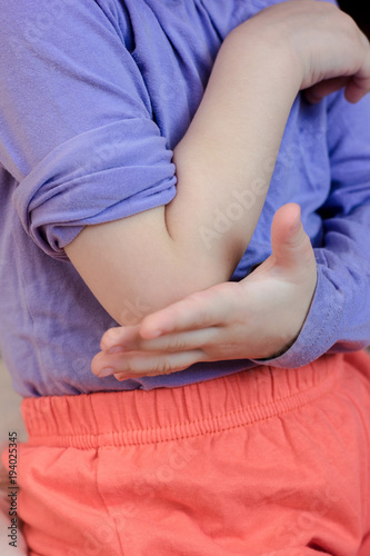 Little kid girl with pain in elbow.