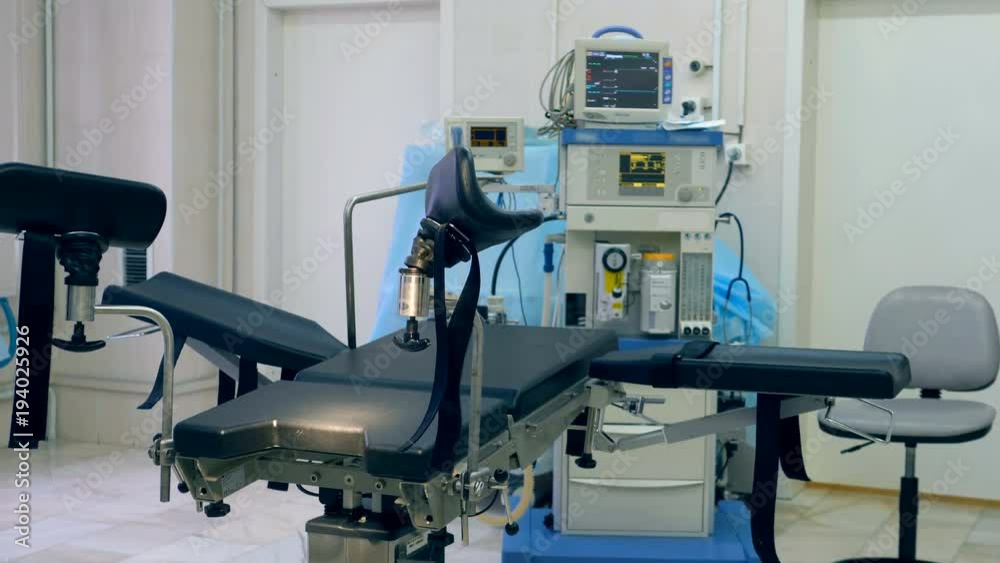 Empty gynecological examination chair in a hospital room Empty gynecological examination chair in a hospital room