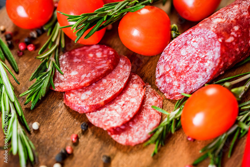 Tasty salami with tomatoes and peppercorn close