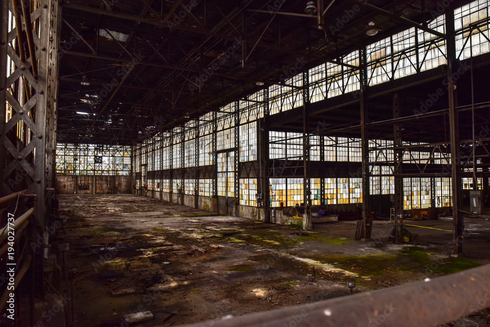 Broken windows in abandoned warehouse industrial space