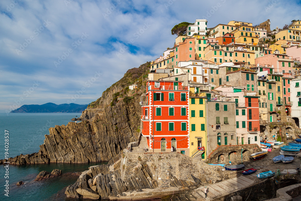 Riomaggiore - first city of the Cique Terre sequence of five hill cities in Liguria, Italy. Great winter seascape of Mediterranean sea. Travel background.