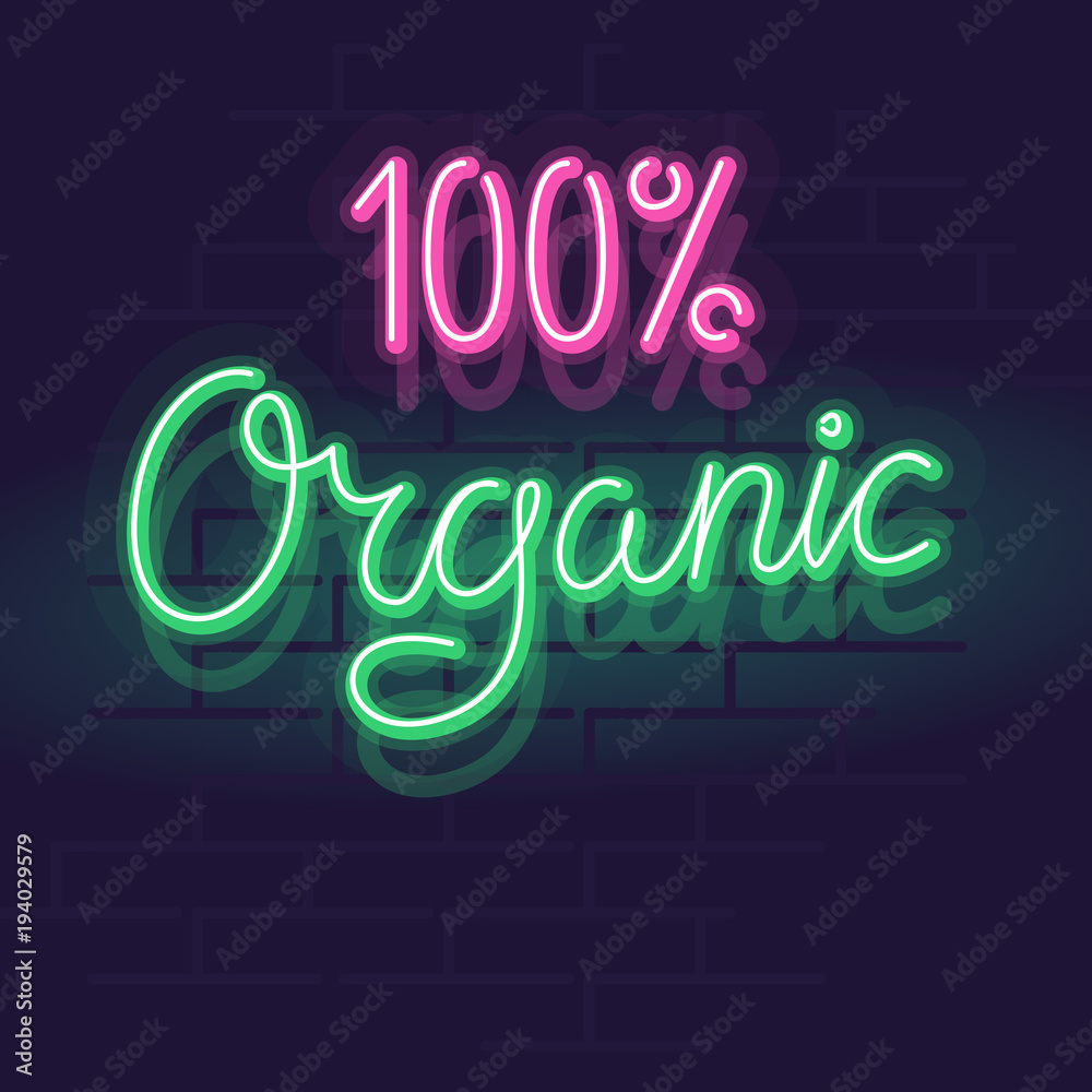 Neon 100% organic label for package, poster or web site. Isolated bright glowing handwritten text on brick wall background. Neon 100% organic label for package, poster or web site. Isolated bright glowing handwritten text on brick wall background.