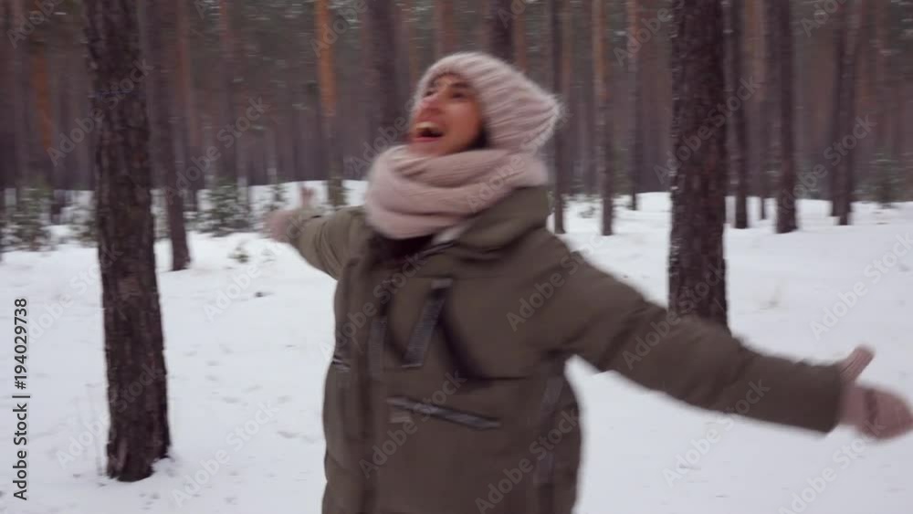 Happy woman spinning around with spread hands in the forest Happy woman spinning around with spread hands in the forest