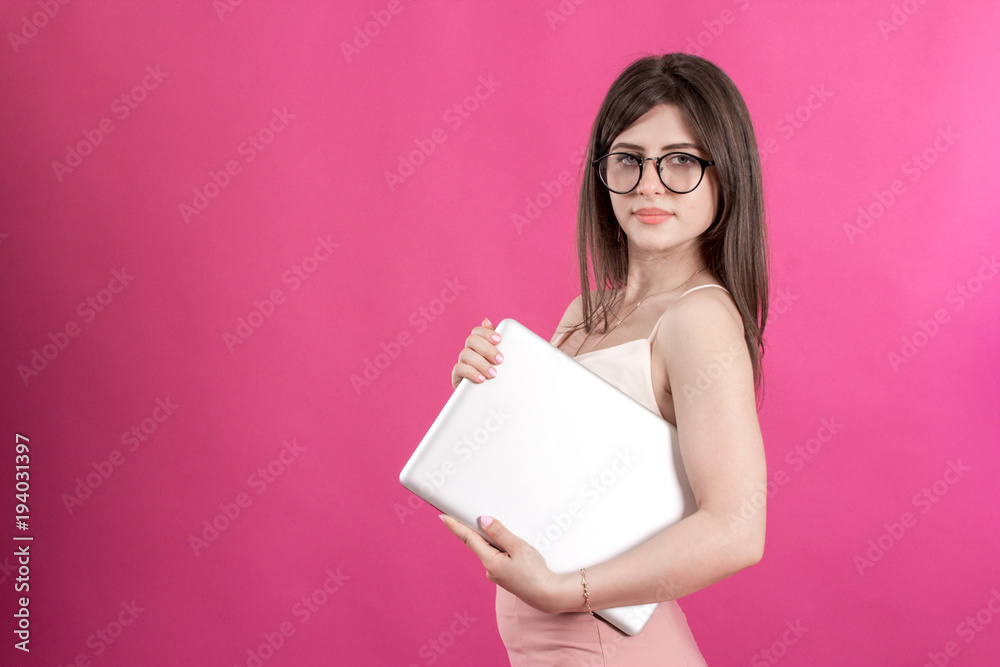 Portrait of beautiful young woman with laptop on pink background Portrait of beautiful young woman with laptop on pink background