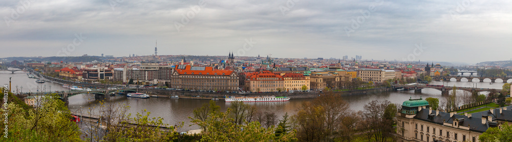 Prague wide panoramic view with old town and river from hill with a park. Gloomy weather.