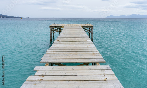 Platform  Wooden pier next to the Mediterranean sea on the island of Ibiza in Spain  holiday and summer scene