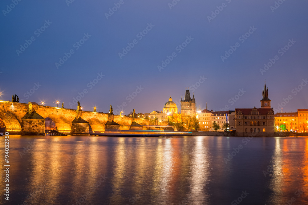 Charles bridge water reflection and old town at night, Prague, Czech republic