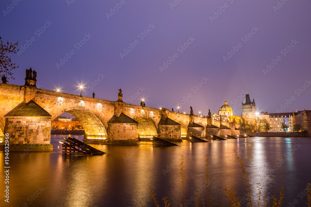 Charles bridge water reflection and old town at night, Prague, Czech republic