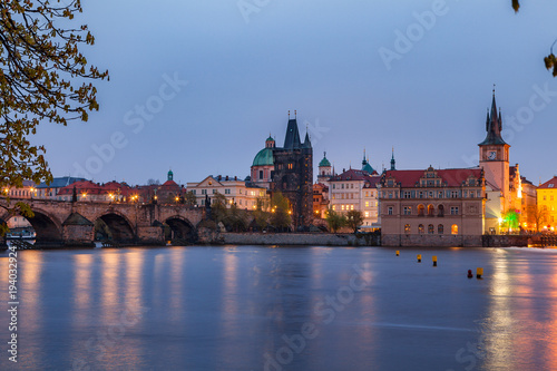 View of night old town of Prague and Charles bridge with reflection in Vltava River