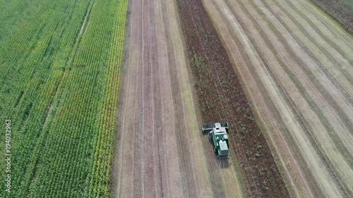 The combine removes the mote that has remained after mowing. A beautiful pattern on the ground after cutting the glass. View from above. Aerial view. 4k Video photo