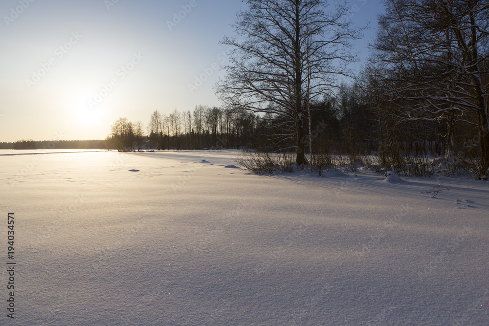 Wintry landscape from Finland. Deep snow with foot prints and ski trails. Wintry landscape from Finland. Deep snow with foot prints and ski trails.
